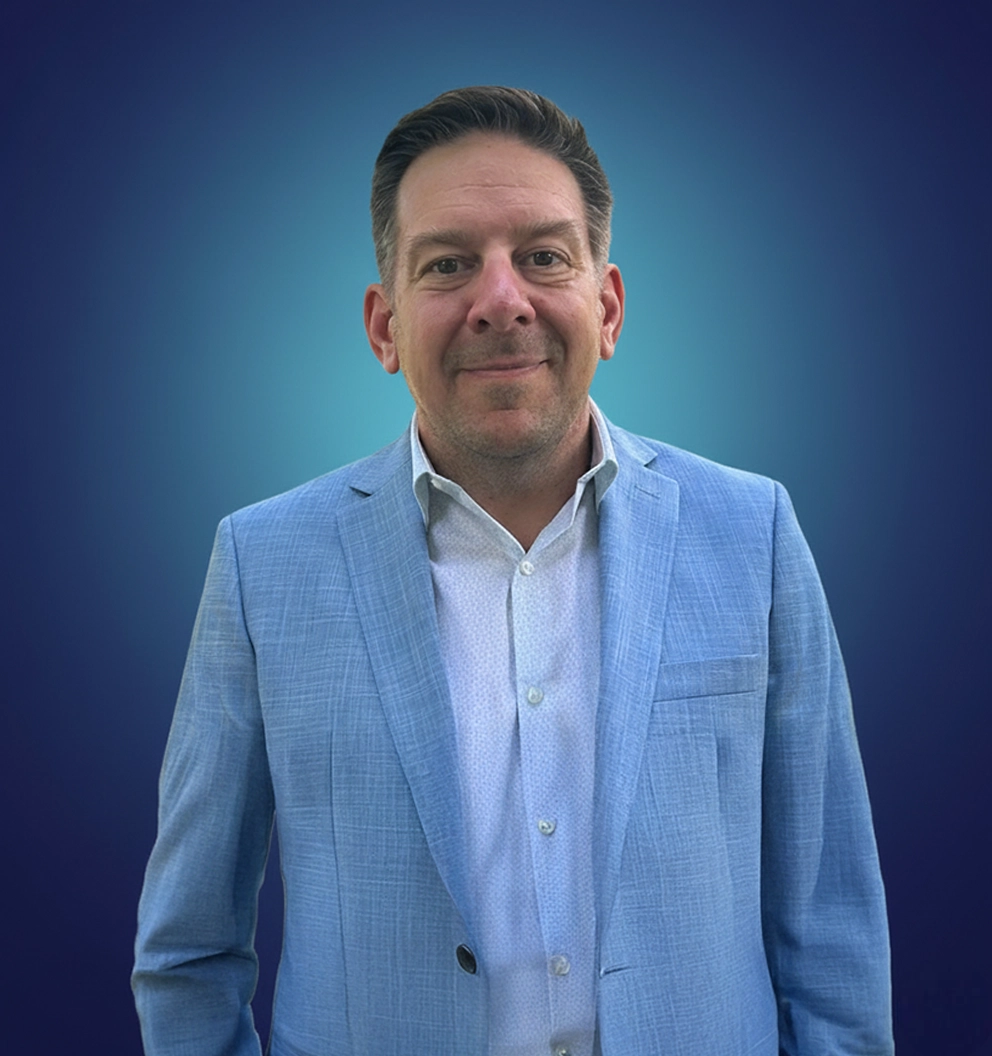 Team Member Colin on a photo studio blue background