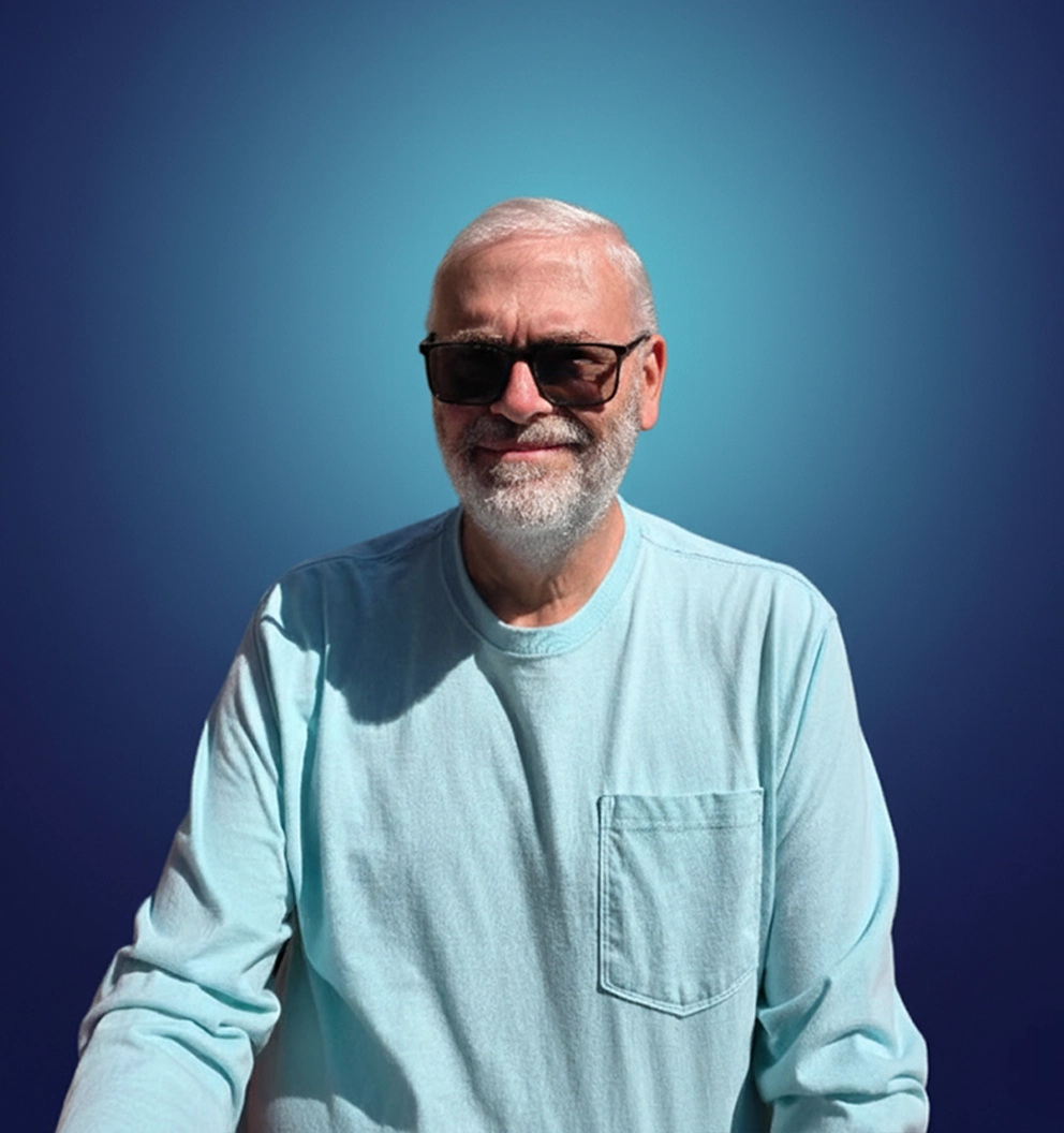 Team Member Daniel Hodge on a photo studio blue background