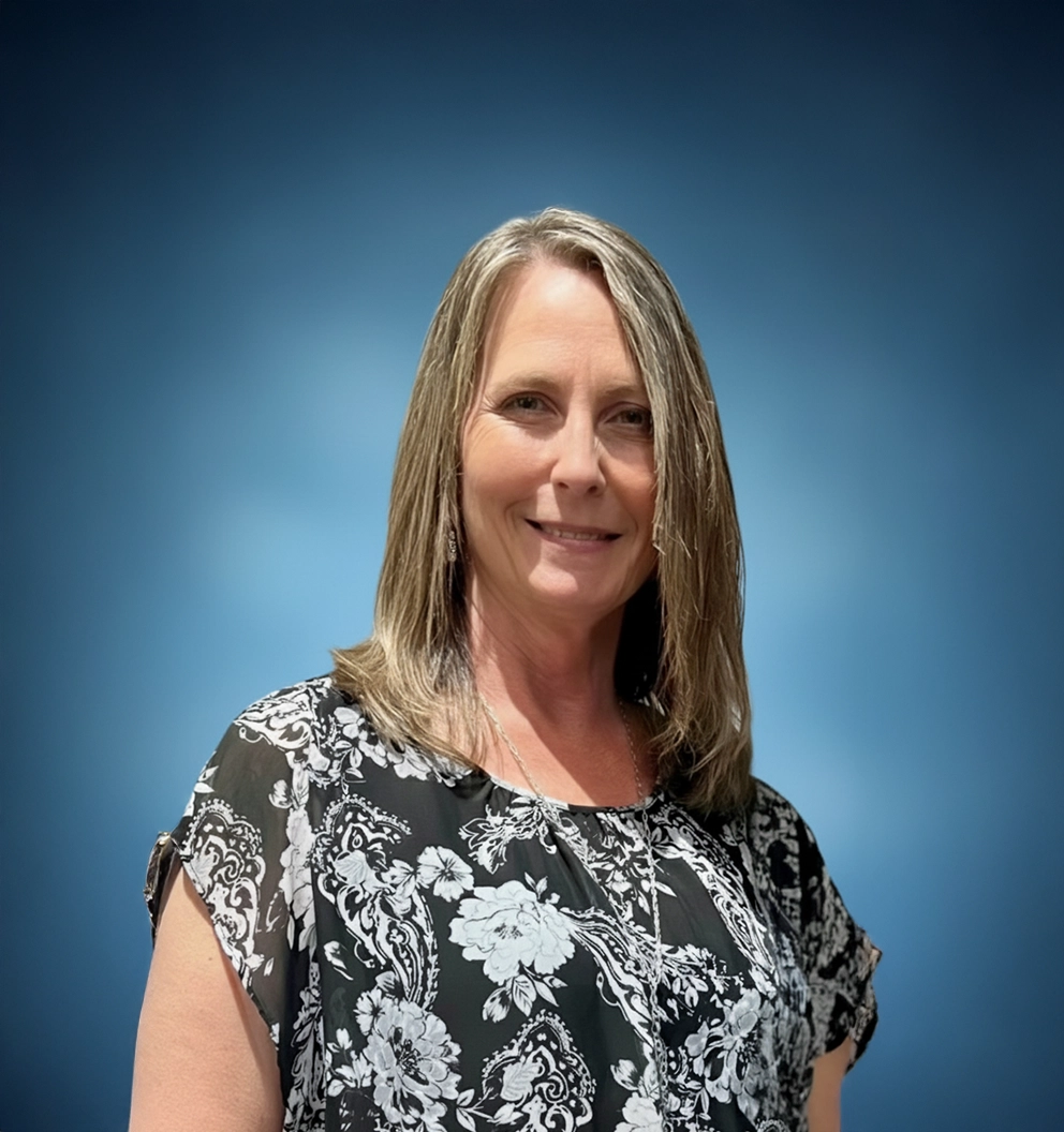 Team Member Melissa on a photo studio blue background