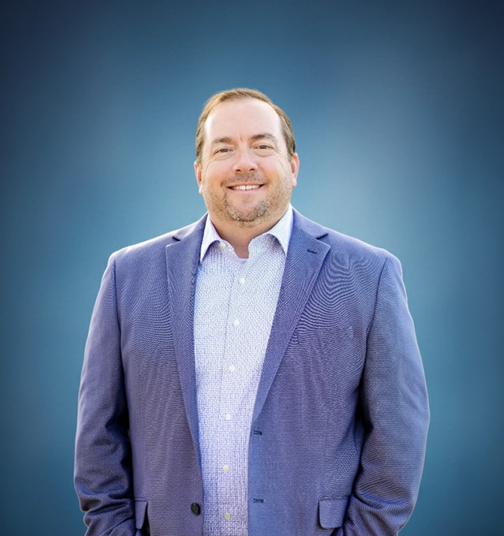 Team Member Tyler on a photo studio blue background
